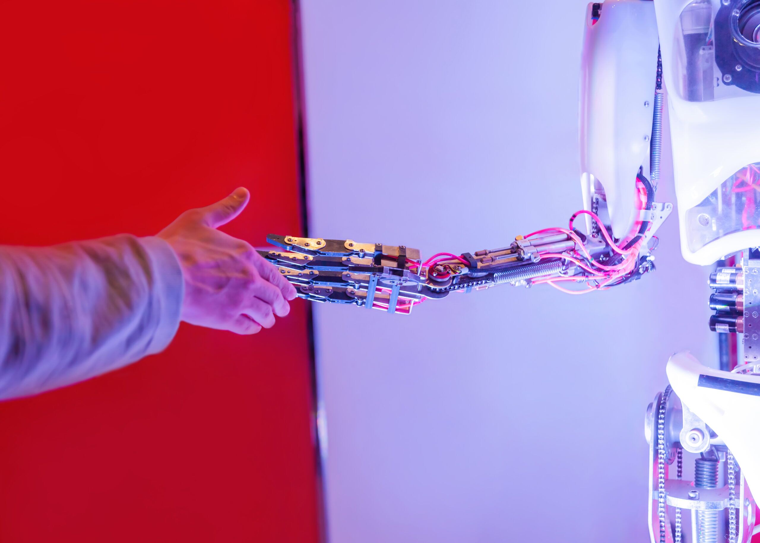 Man gives his hand to shake it to robot.