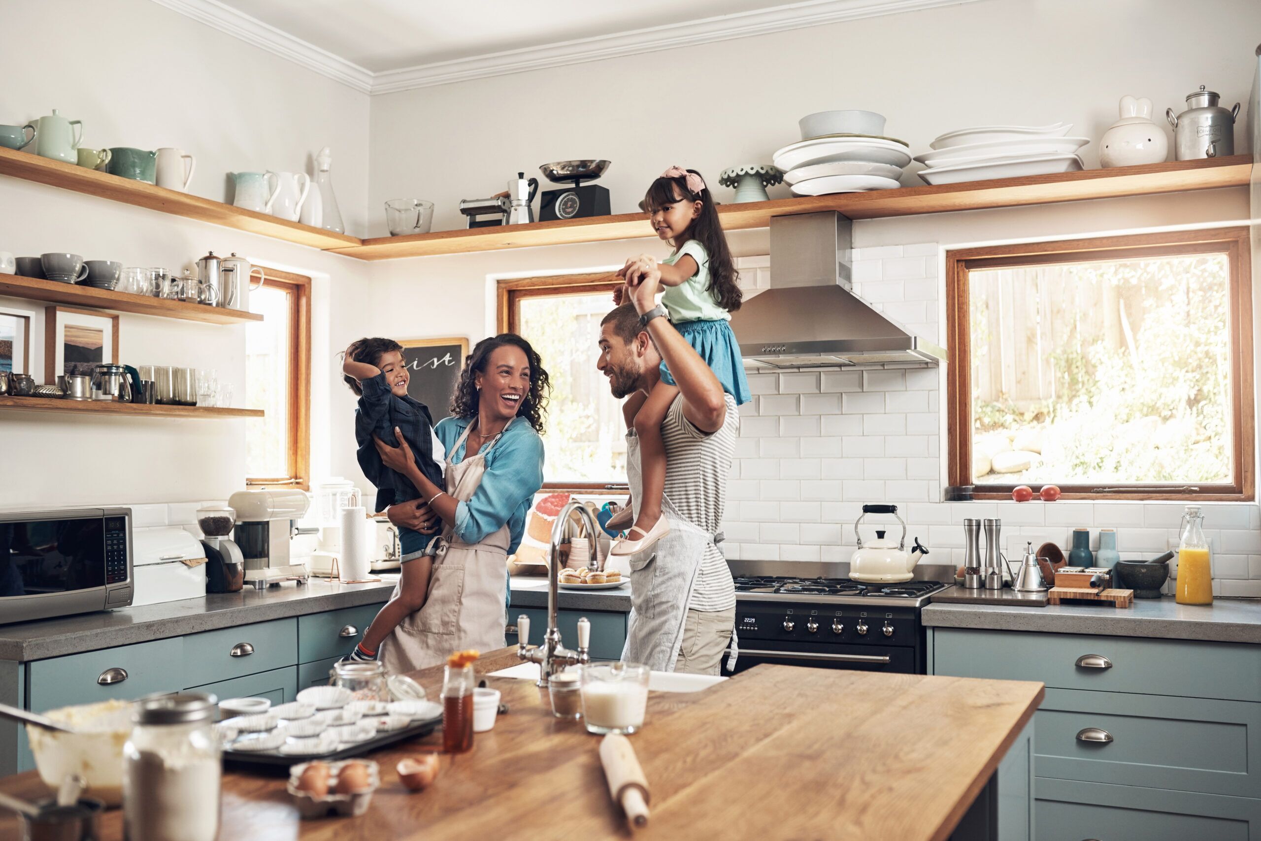 Shot of a young family spending quality time together in the kitchen at home. Family imagining their life in a new build home.